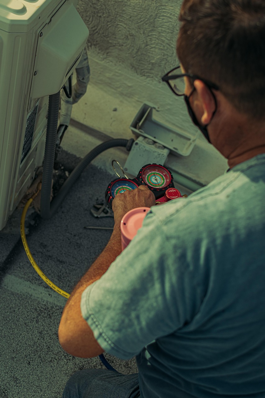 HVAC technician servicing an air conditioning unit